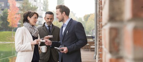 Business people talking and exchanging business cards